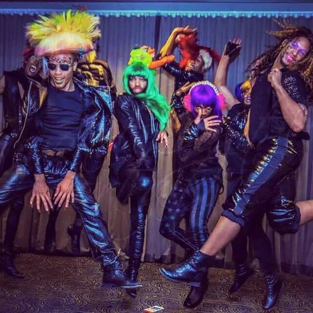 A group of people in colorful wigs